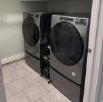 Full size front loaded washer and dryer located downstairs